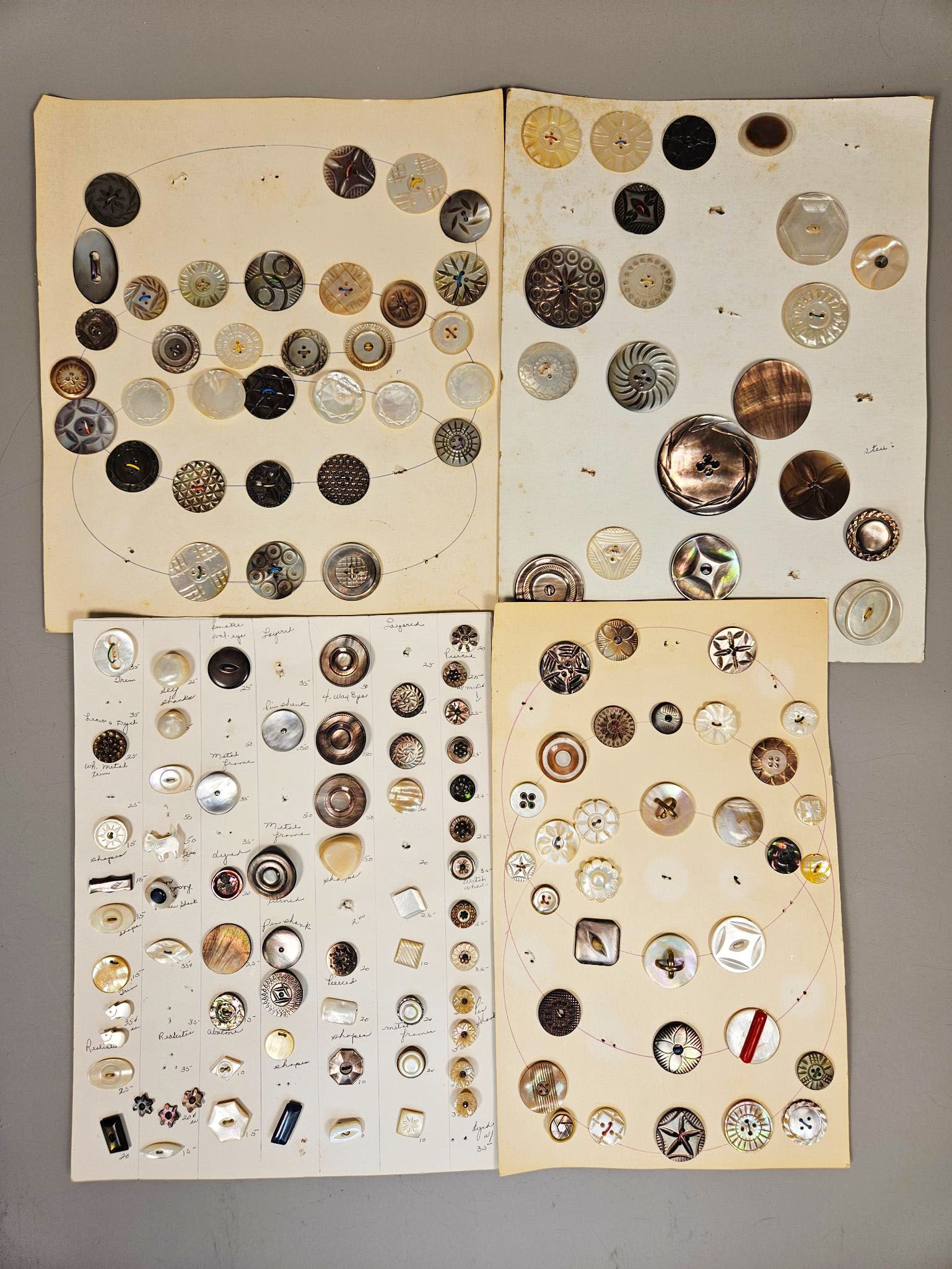 A group of Antique Cards of Fancy Pearl Buttons: A group of antique cards, each displaying a diverse assortment of fancy pearl buttons. The buttons are predominantly crafted from mother-of-pearl and abalone shell, exhibiting characteristic iridescen