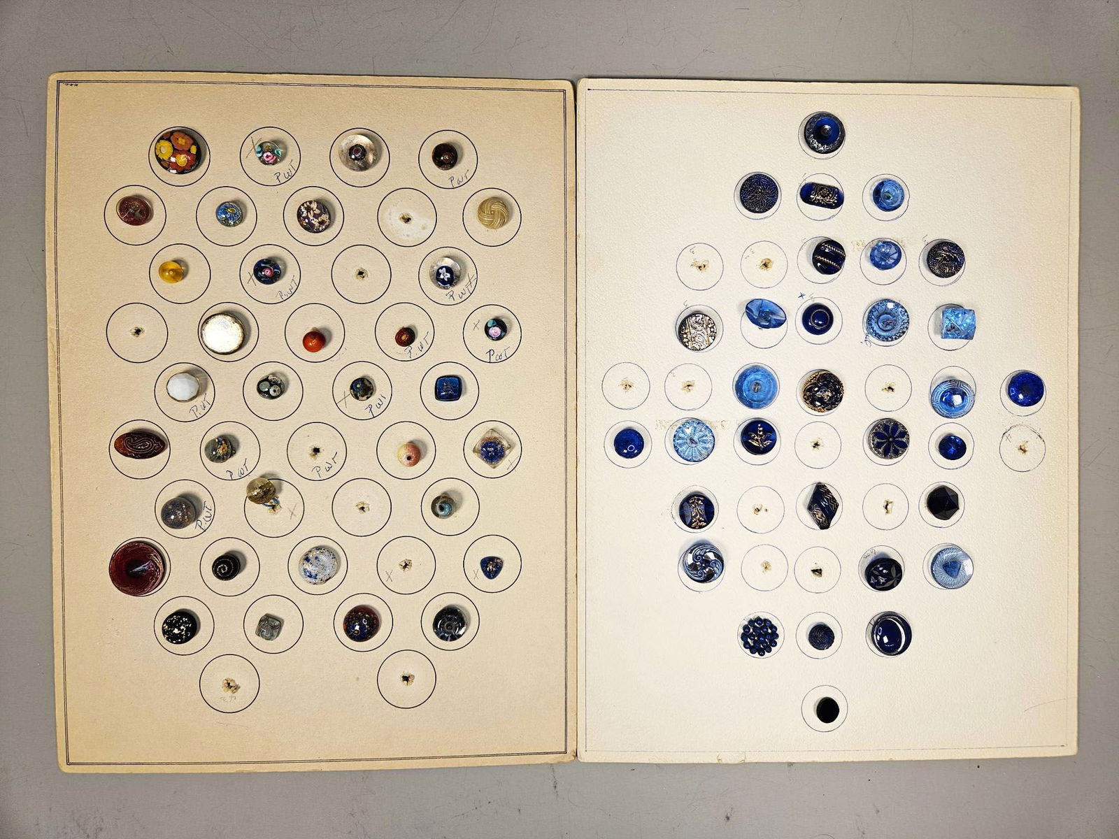 A Collection of Vintage Glass and Assorted Buttons, including Paperweight Styles, Late 19th to: A group of assorted vintage buttons presented on group of display cards. The first card features a diverse array of round and irregularly shaped buttons, predominantly glass examples encompassing mill