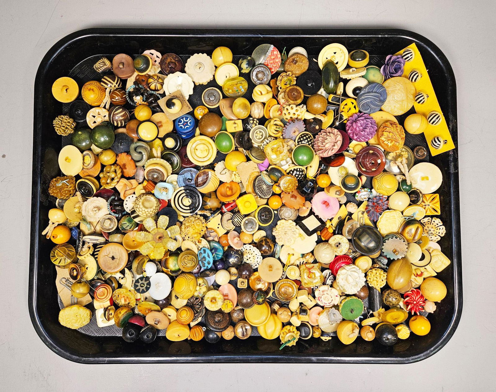 A Collection of Vintage and Antique Buttons, including Bakelite, Celluloid, and Natural Materials: A substantial and highly diverse collection of several group of vintage and antique buttons. The assortment is primarily composed of various early plastics such as Bakelite, celluloid, and other resin