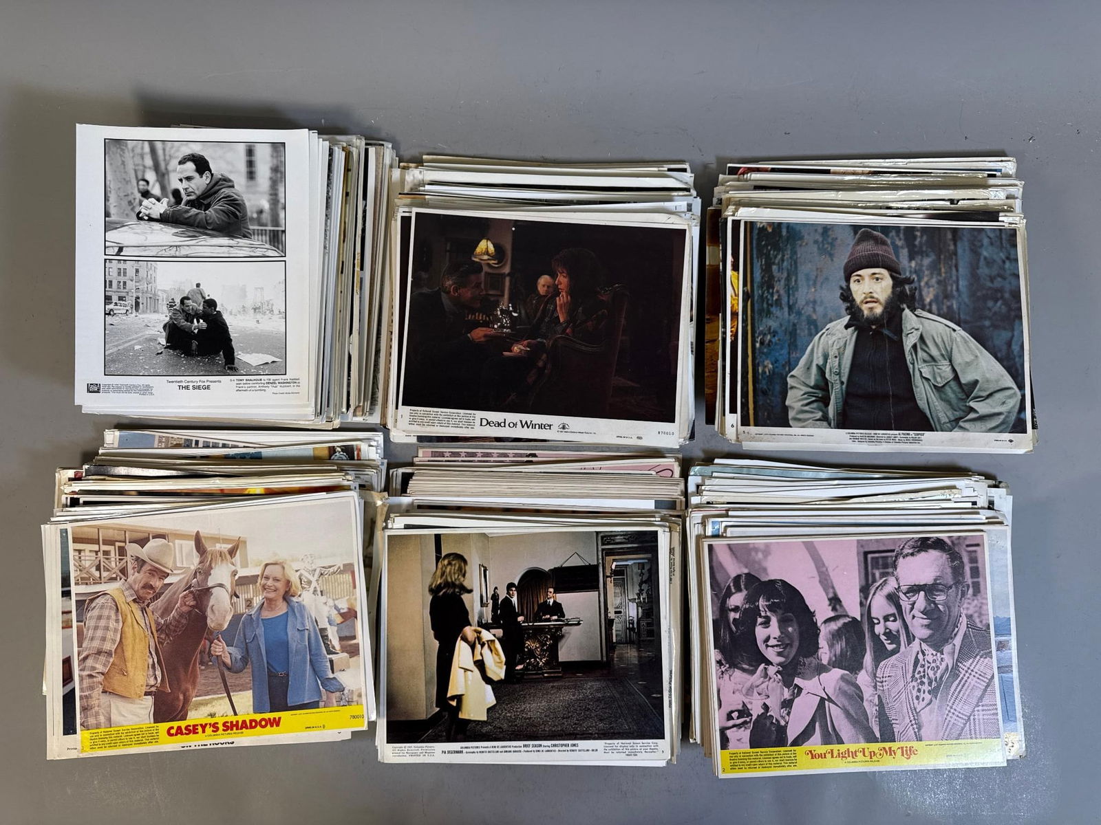 A Collection of Vintage Promotional Movie and Music Publicity Photos: A collection of vintage promotional movie and music publicity photographs, primarily dating from the late 1970s through the late 1990s. The collection comprises multiple stacks of paper photographs, i