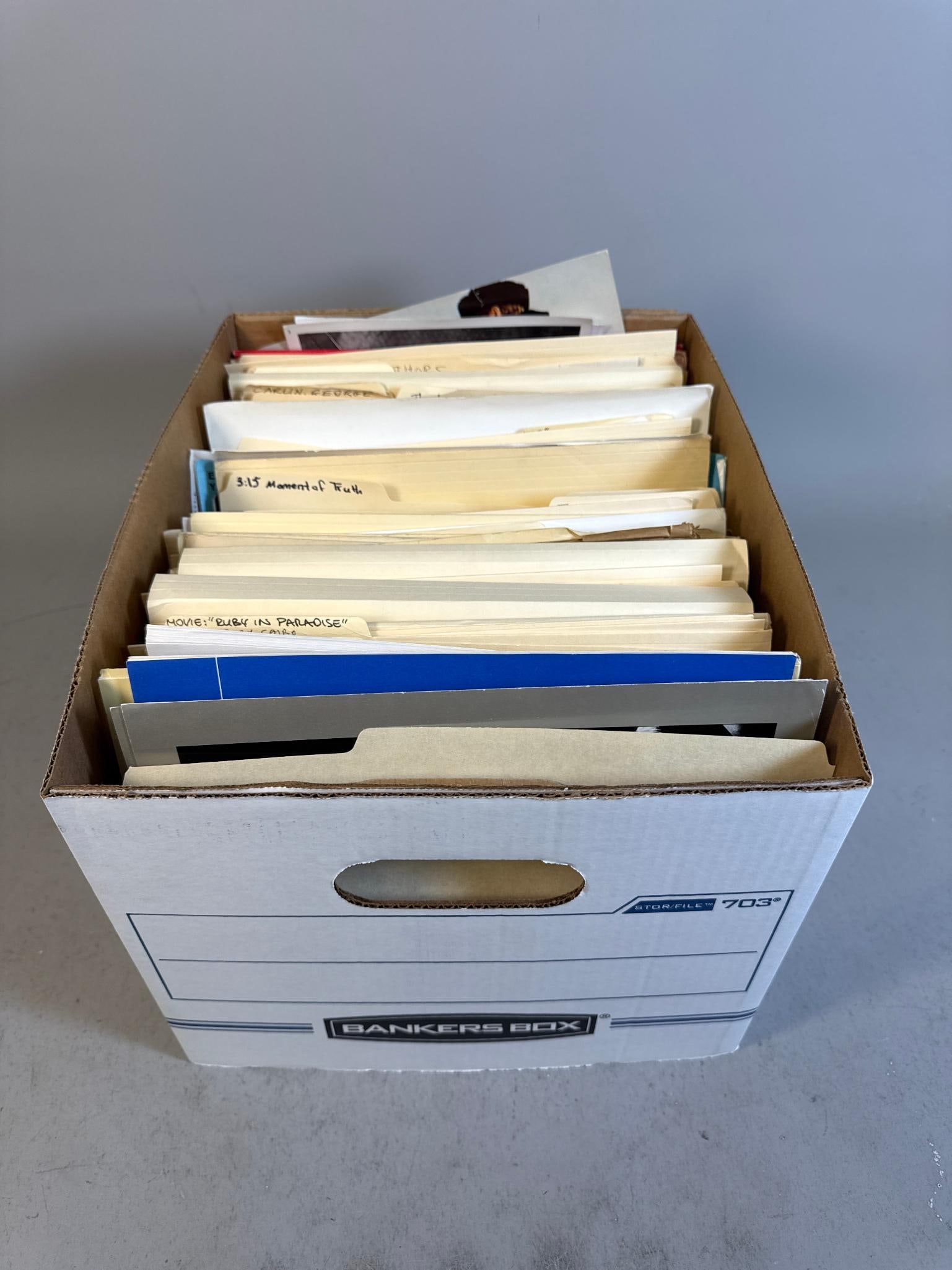 A Collection of Promotional Movie and Television Publicity Materials, Mid-20th Century to Early: A collection of promotional materials for film and television productions, housed in a brown cardboard "Bankers Box" (Stor-File 703). The contents primarily comprise file folders, publicity photograph