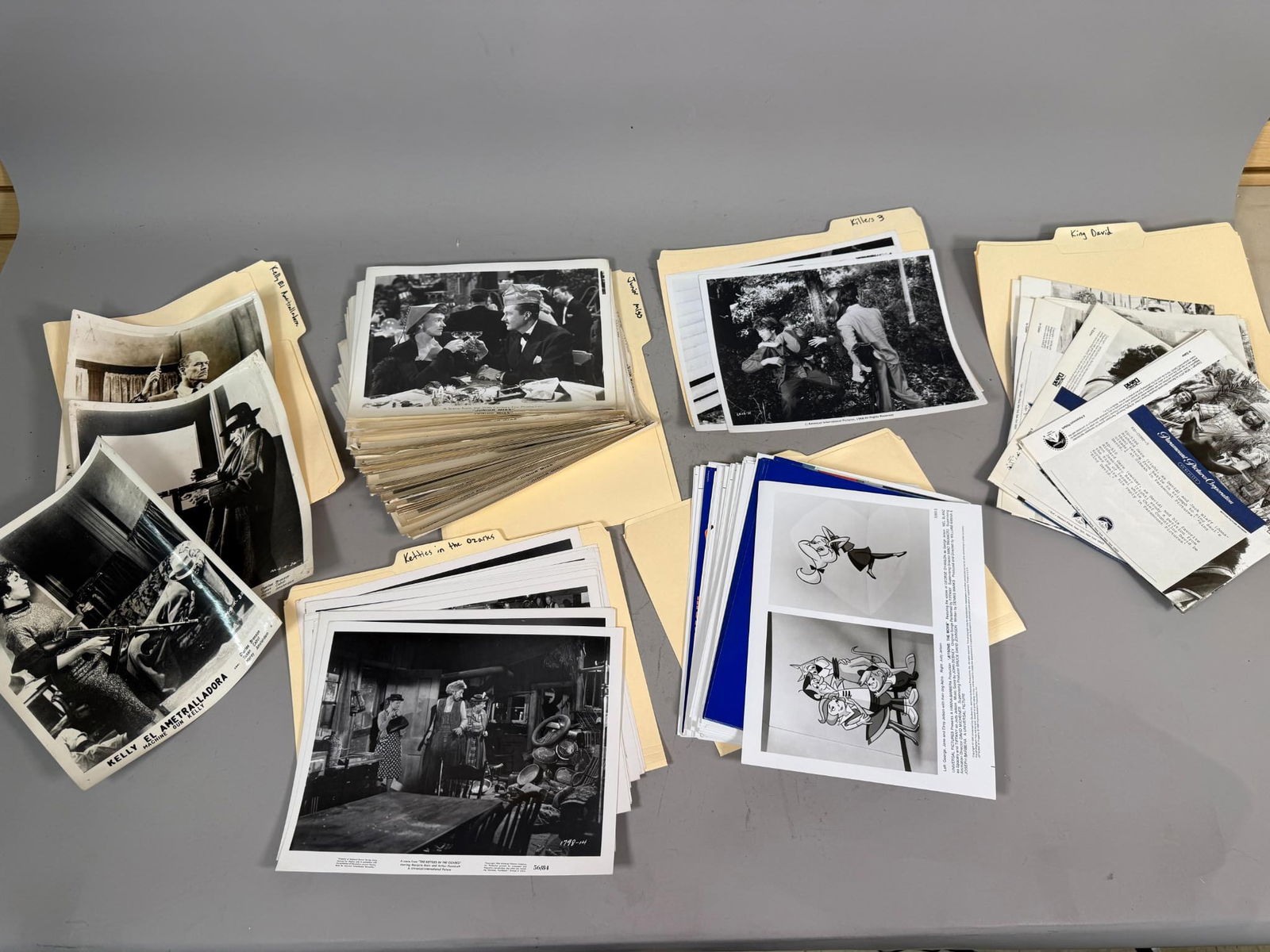 A Large Collection of Vintage and Modern Film Stills and Press Photos, 1945-1990: A substantial collection of vintage and more recent film stills, publicity photographs, and associated press release materials, primarily black and white glossy prints but also including some color ph