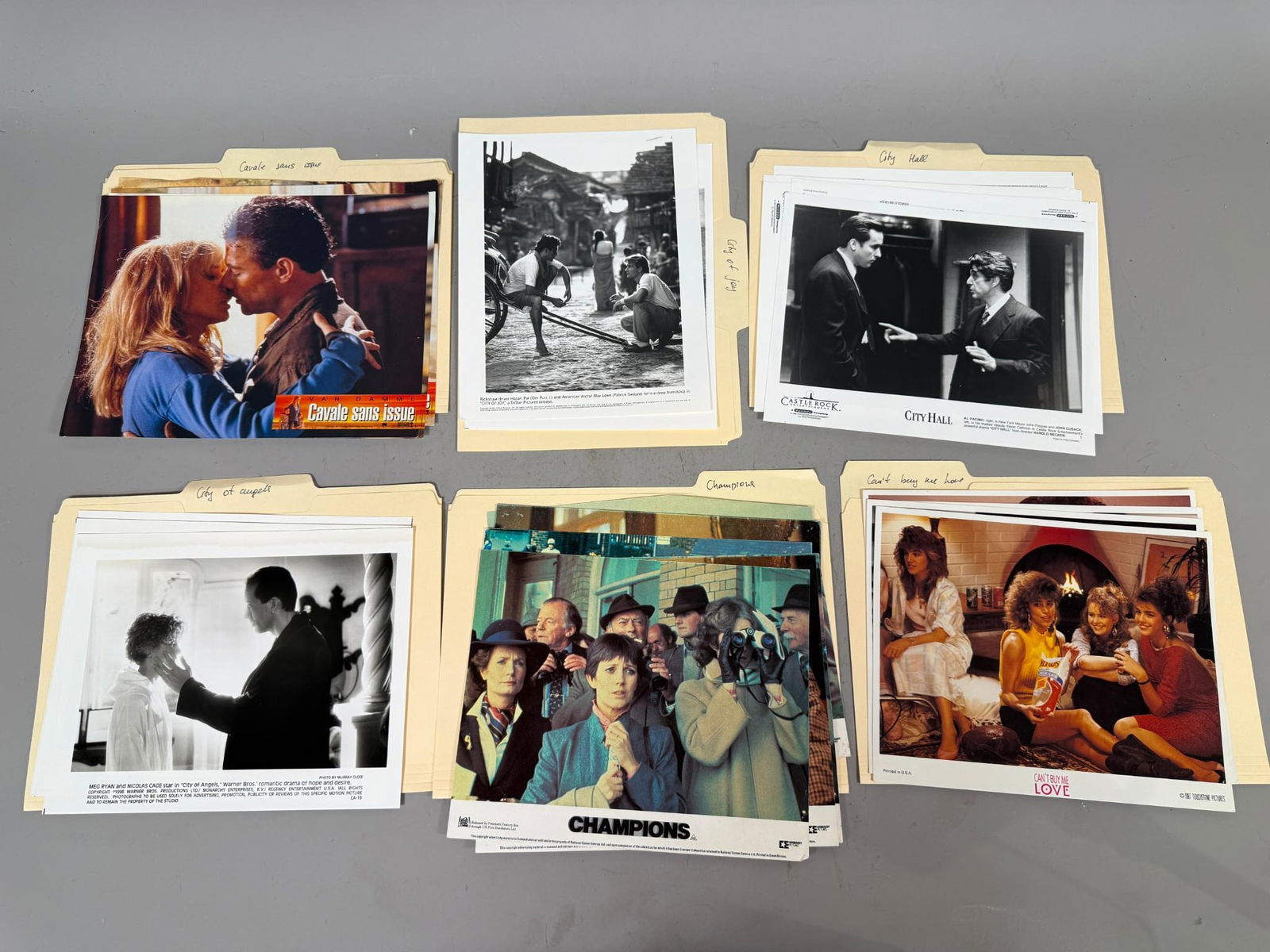 A Group of Promotional Film Stills, Late 1980s-1990s, including 'City of Joy' and 'Nowhere to Run': A group of promotional film stills, comprising both black and white and color glossy photographs, dating from the late 1980s to late 1990s. The collection features scenes and actors from various films