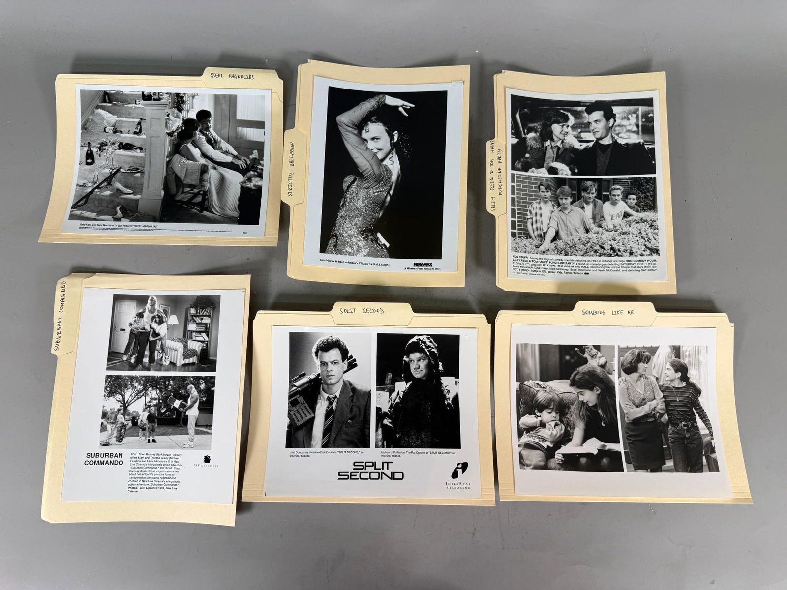 Seven Late 20th Century Movie and Television Press Photo Folders: This lot comprises group of manila file folders, each containing or more black-and-white promotional still photographs from various films and television productions. The folders are hand-labeled with