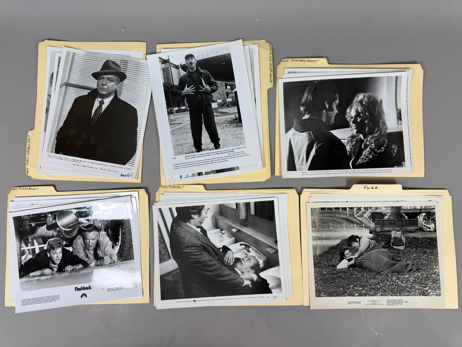 A Collection of Vintage Black and White Movie Publicity Photographs, 1960s-1980s: This collection comprises vintage black and white movie publicity photographs, primarily dating from the late 1960s to the late 1980s. Each photograph is a silver gelatin print on photographic paper,