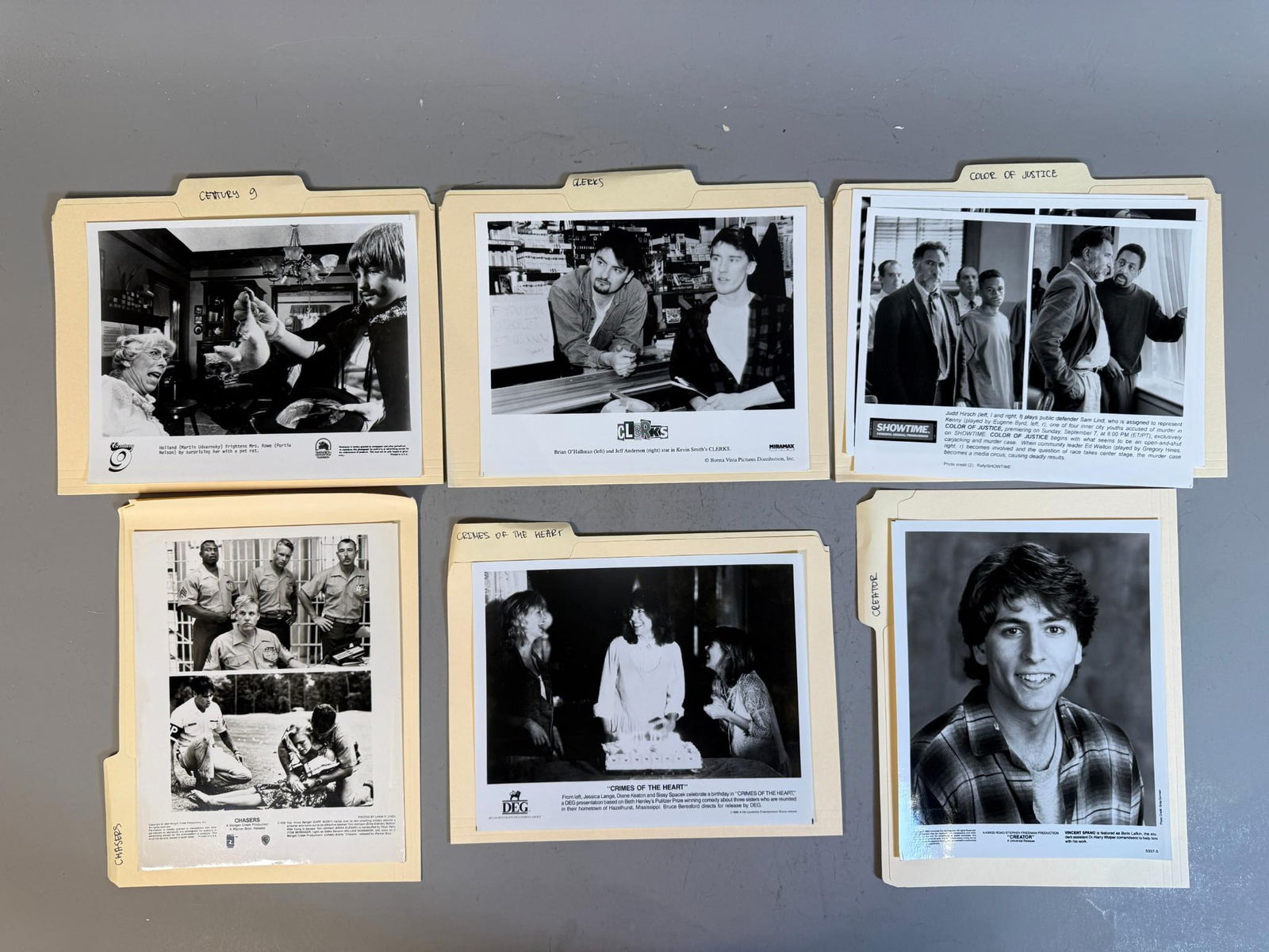 A Collection of Late 20th Century Film and Television Promotional Press Stills: A group of manila folders, each containing or more vintage black and white photographic stills. These photographs function as promotional press stills for various film and television productions, feat