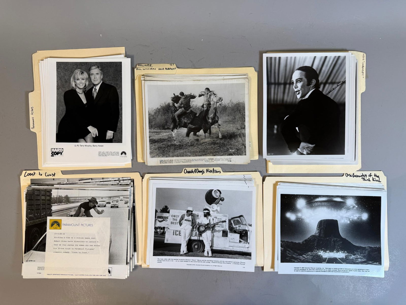 A Collection of Film and Television Publicity Stills, including 'Hard Copy' with Terry Murphy and: A collection of numerous black and white photographic prints, primarily serving as publicity stills and promotional materials for various films and television programs. The images depict diverse subje