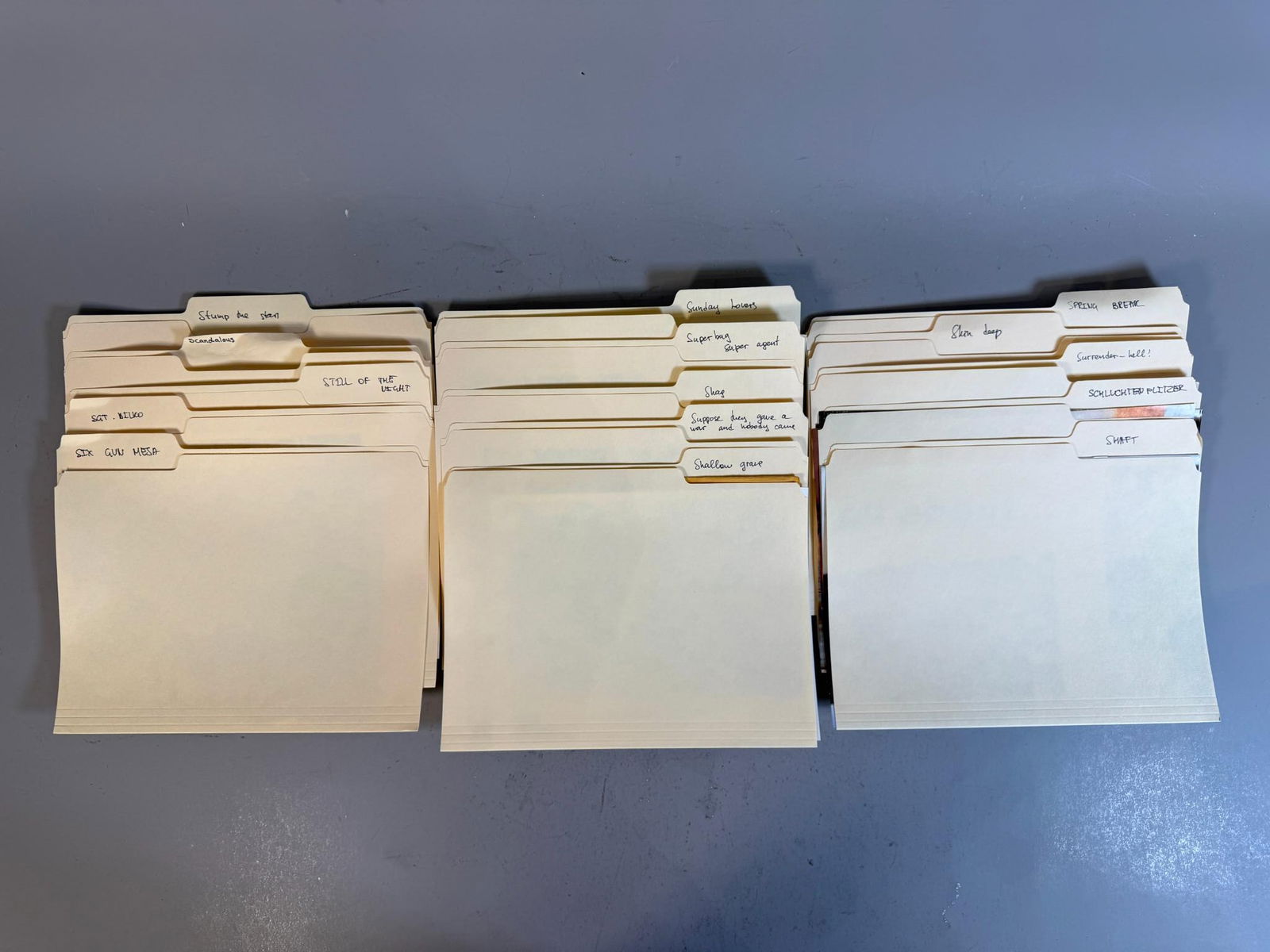 A Collection of Vintage Film and Television Production Stills and Documents, circa Mid-20th Century: A group of vintage manila file folders, organized into group of rows, containing a diverse assortment of photographic prints and printed documents related to film and television productions. The major