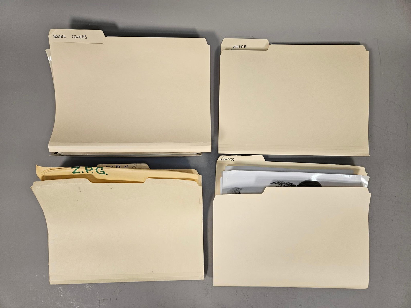 A Group of Manila File Folders containing Photographic Prints, including Zappa and Zardoz: A group of letter-size manila file folders with 1/3-cut tabs, consistent with types manufactured by Smead and other office supply brands. The lot comprises group of stacks of such folders, labeled in 