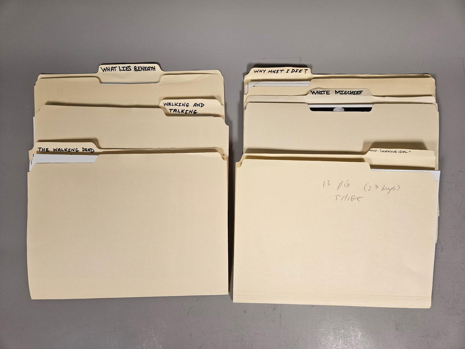 A Collection of Film and Television Publicity Stills, Late 20th to Early 21st Century: A collection of black and white photographic publicity stills, predominantly from various film and television productions. The prints are housed within group of stacks of standard manila file folders,