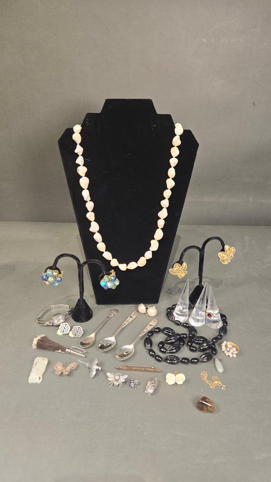 A Collection of Costume Jewelry, .800 Silver Spoons, and Assorted Accessories including Kramer and: This diverse lot, as indicated by the accompanying label 'Costume Jewelry, Pewter, Jade and More,' comprises numerous pieces of costume jewelry and assorted accessories. The collection includes a vari