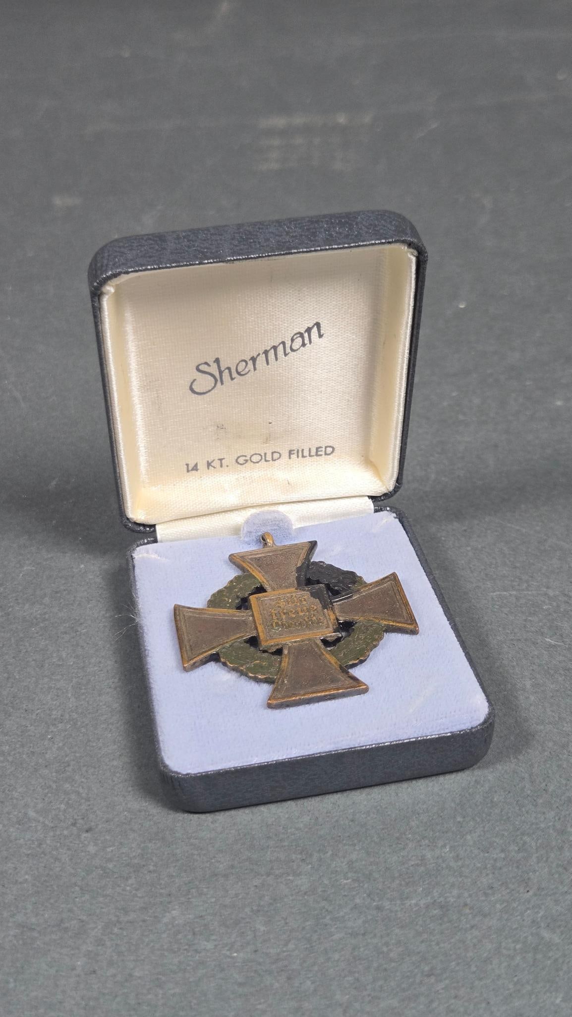 Germany, Third Reich. A Civil Service Long Service Award: A Third Reich Civil Service Long Service Award. This cross-shaped medal features a Maltese cross design encircled by an oak leaf wreath. The obverse displays a central rectangular panel inscribed with