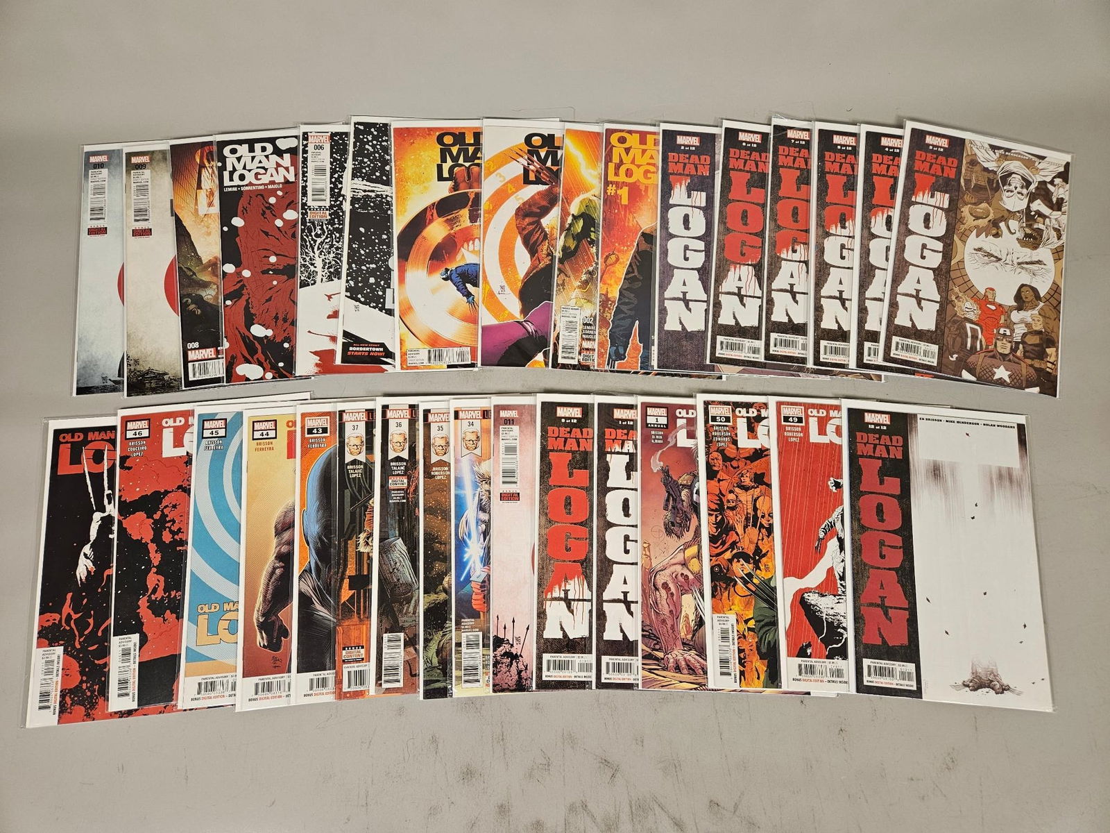 A Collection of 33 Marvel Comic Books, 'Old Man Logan' and 'Dead Man Logan' Series: A collection of 33 modern American comic books published by Marvel Comics, primarily from the "OLD MAN LOGAN" and "DEAD MAN LOGAN" series. The collection spans various issue numbers, including #1 and