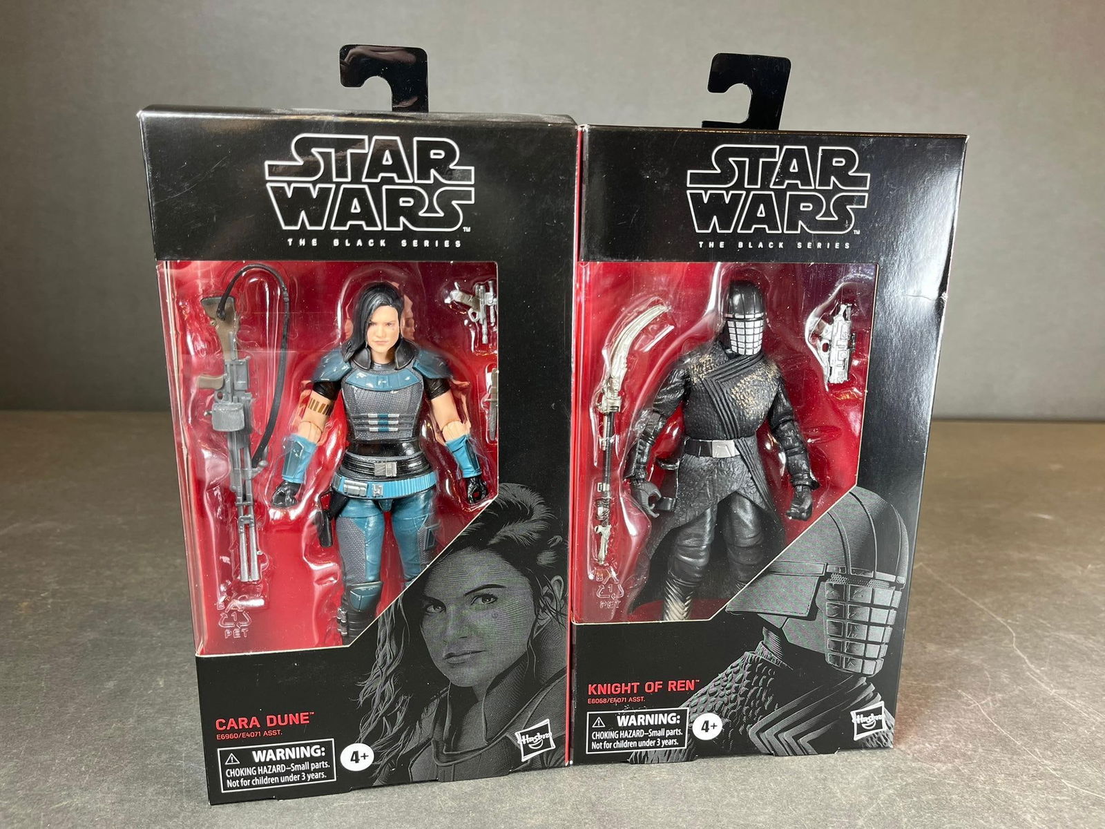 A Pair of Hasbro Star Wars The Black Series 6-inch Action Figures: Knight of Ren and Cara Dune: A Hasbro Star Wars The Black Series 6-inch scale plastic action figure, "Knight of Ren" (Figure 105, E8068/E8071 ASST.). The figure is presented in its original black and red cardboard box packaging w