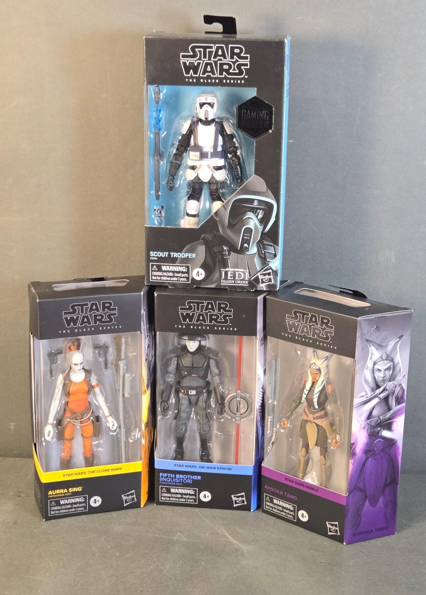 A Group of Four Star Wars The Black Series Action Figures, including Gaming Greats Scout Trooper: A group of four new-in-box Star Wars "The Black Series" action figures by Hasbro. This collection includes a "SCOUT TROOPER" from "JEDI FALLEN ORDER" (branded "GAMING GREATS"), "AURRA SING" from "STAR