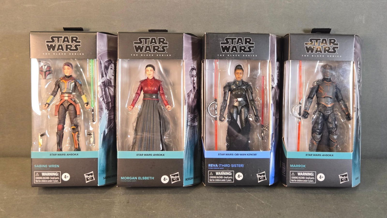 A Group of Four Star Wars The Black Series Action Figures, including Sabine Wren, Morgan Elsbeth,: A group of four 'Star Wars The Black Series' action figures, each housed in its original, factory-sealed cardboard window box packaging. The collection includes Sabine Wren, Morgan Elsbeth, and Marrok