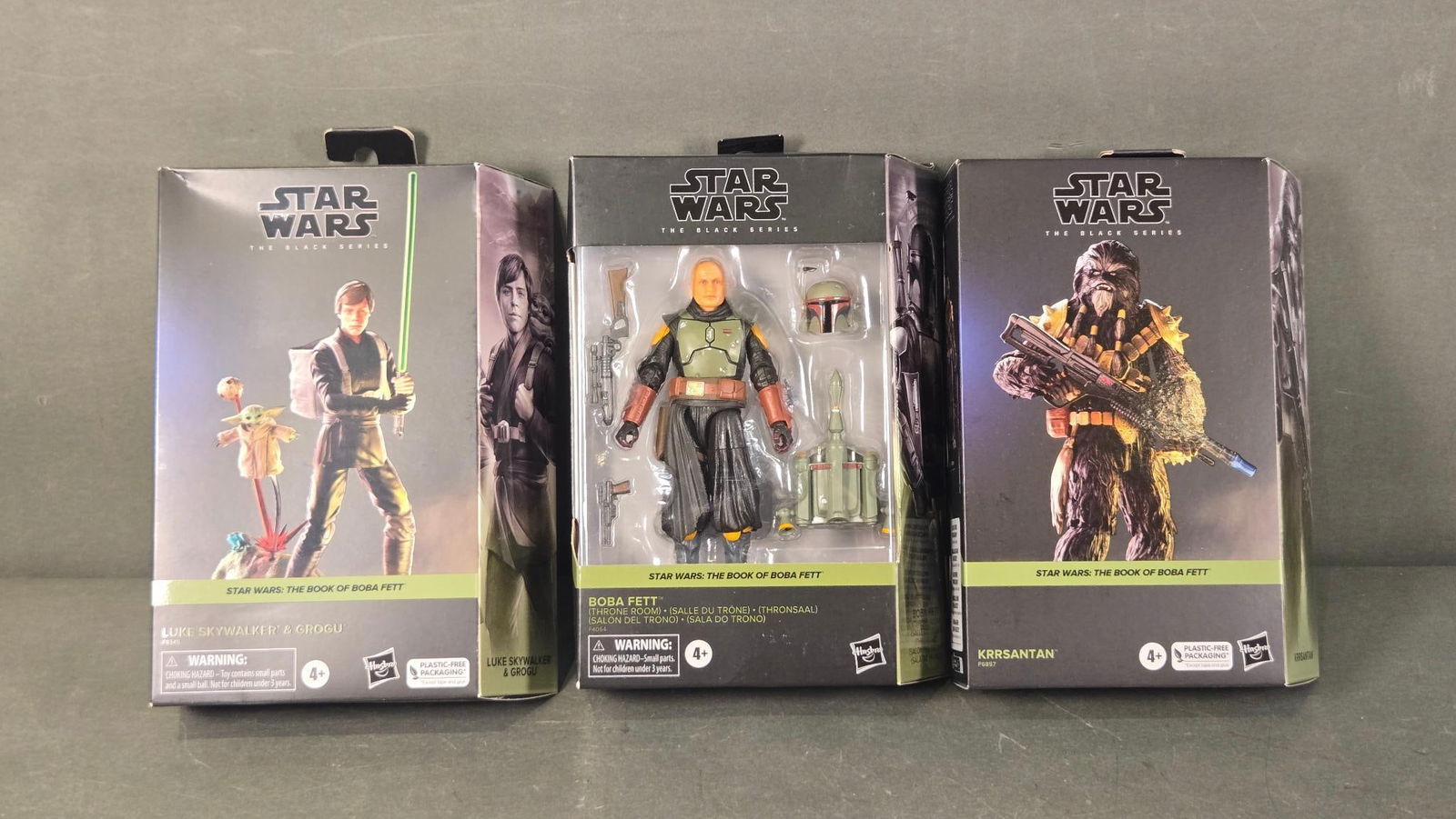 Three Star Wars: The Black Series 'The Book of Boba Fett' Action Figures, including Boba Fett: A lot comprising three contemporary Star Wars: The Black Series action figures, all from 'The Book of Boba Fett' sub-series. The figures include 'Luke Skywalker & Grogu,' 'Boba Fett (Throne Room),' an