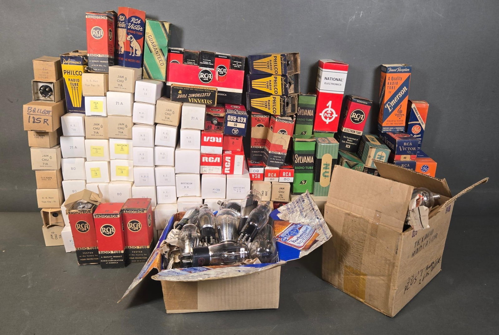 A Collection of Mid-20th Century Vintage Glass and Metal Vacuum Tubes: A substantial collection of vintage glass and metal vacuum tubes, commonly known as radio tubes, primarily from the mid-20th century. The collection includes tubes from manufacturers such as RCA (Radi