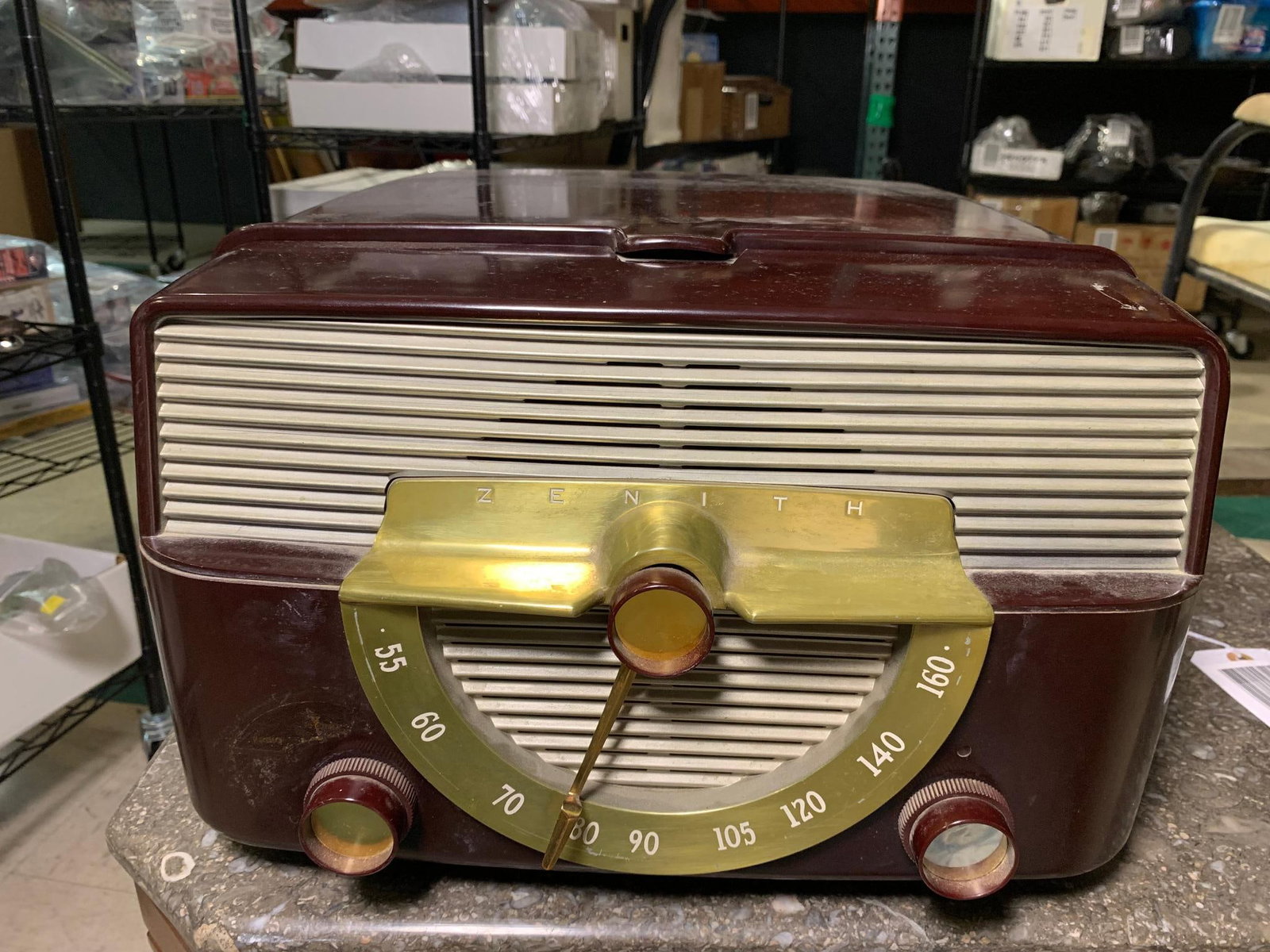 Zenith Cobra-Matic Bakelite AM Radio Phonograph, Model K666, circa 1953: A Zenith Cobra-Matic Bakelite AM Radio Phonograph, Model K666, circa 1953. This vintage console unit features a dark reddish-brown molded bakelite cabinet with a slightly curved, streamlined profile.
