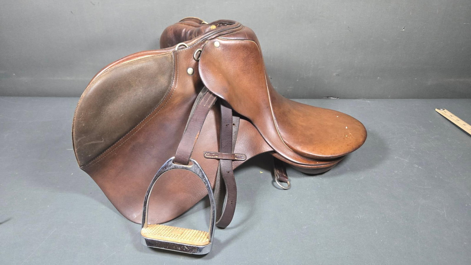 Stubben Made in Ireland English Horse Riding Saddle: A Stubben English horse riding saddle, manufactured by Stubben Ireland Ltd. The saddle is primarily constructed from various shades of brown leather, including areas with a suede-like texture on the k