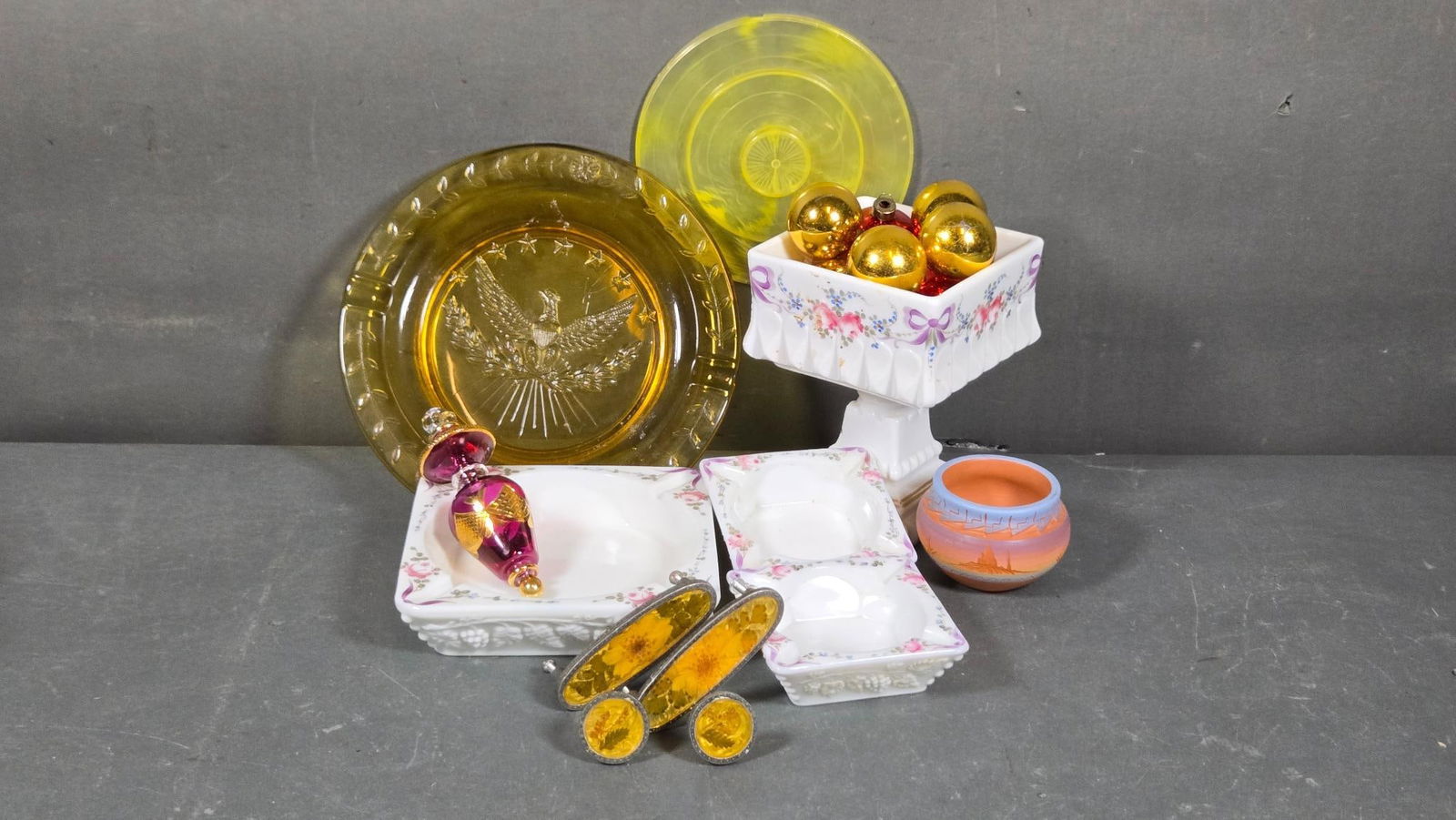 A Collection of Westmoreland Milk Glass and Decorative Objects: A diverse collection featuring three Westmoreland milk glass pieces: one square pedestal dish and two smaller square dishes. These are adorned with hand-painted pink roses, blue flowers, and purple ri