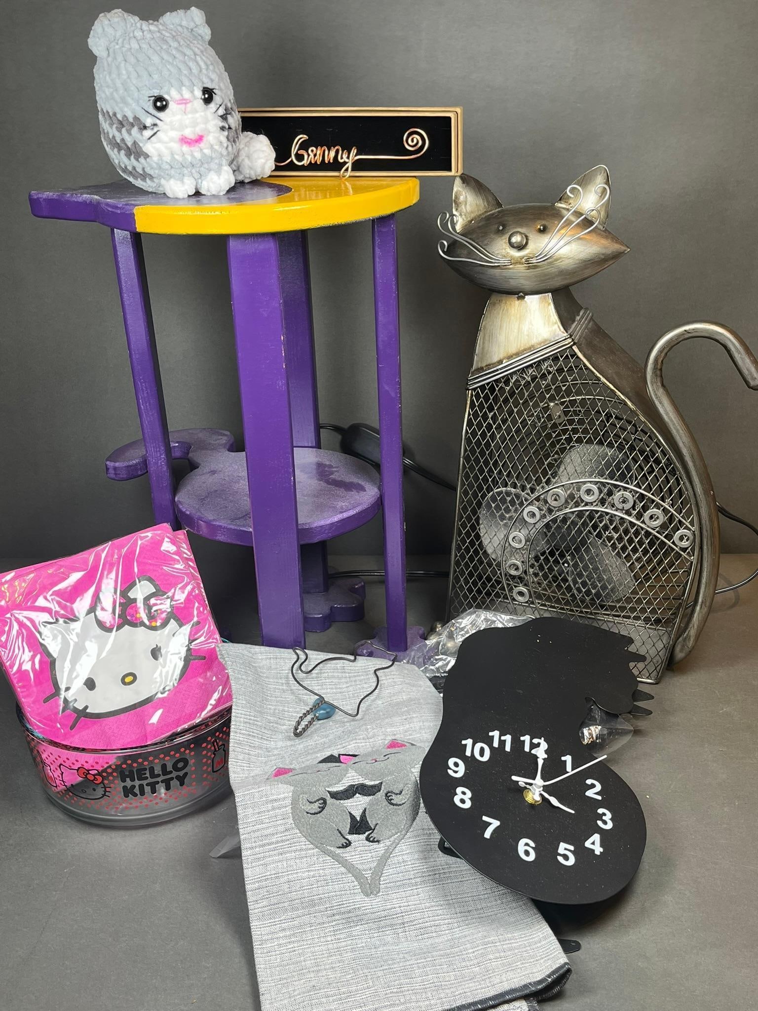 A Collection of Hello Kitty and Cat-Themed Decorative and Functional Items: A collection of contemporary cat-themed decorative and functional items. The lot includes two factory-sealed packs of "DesignWare Luncheon Napkins" adorned with the "Hello Kitty" character, dated 2013