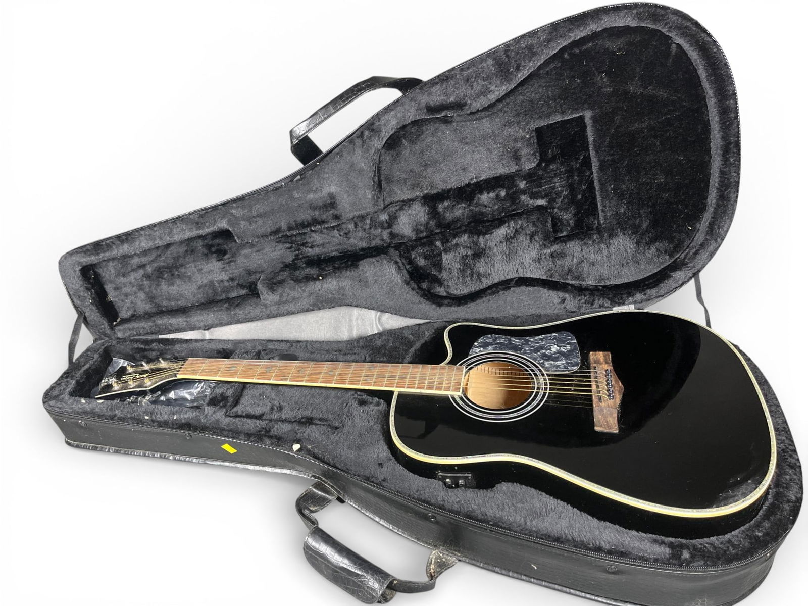Randy Jackson 2013 True Faith Collection Limited Edition Acoustic Electric Guitar: A Randy Jackson 2013 True Faith Collection Limited Edition Acoustic Electric Guitar. This black electro-acoustic guitar features a dreadnought-style body with a single cutaway, white binding, and a