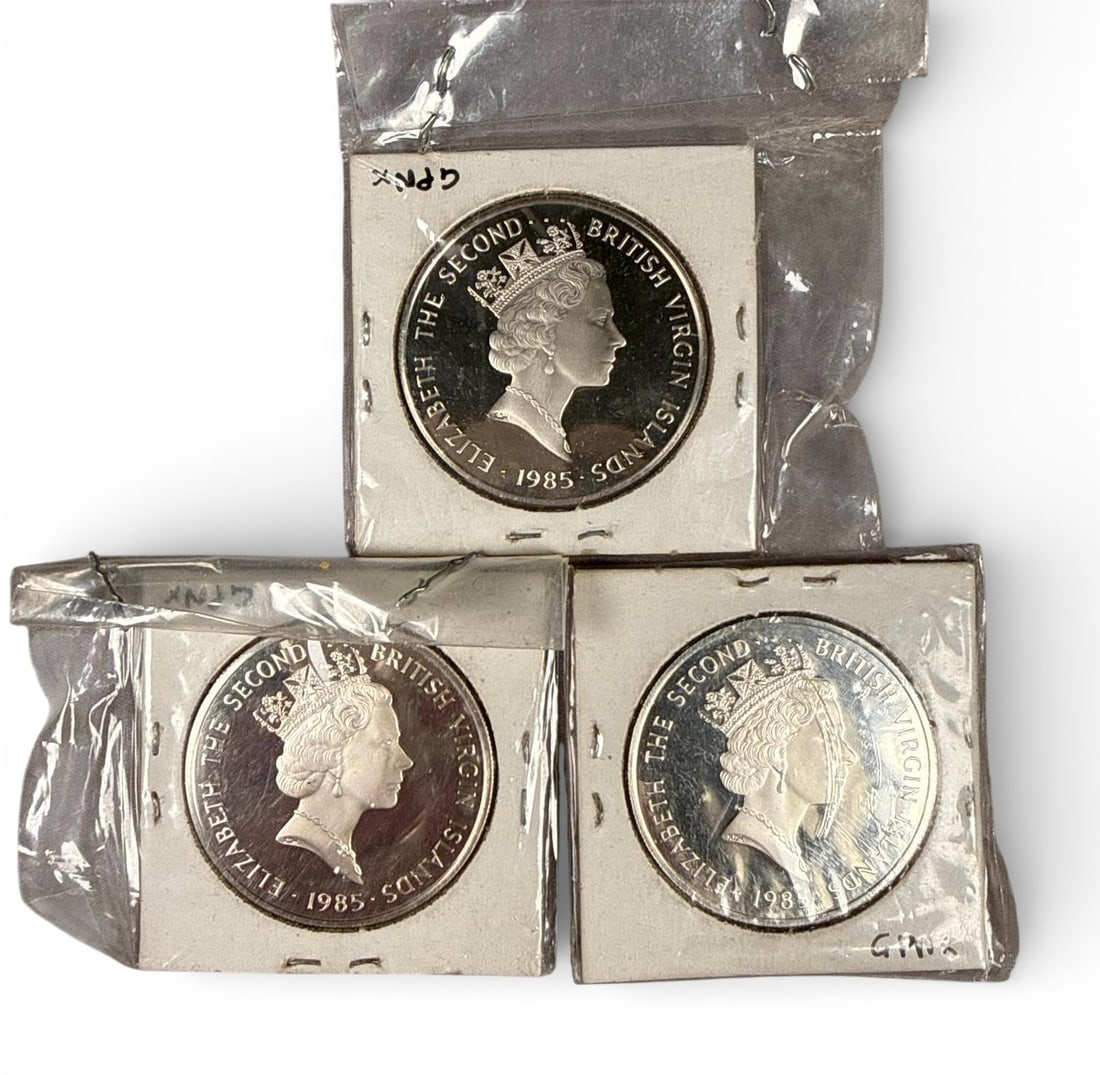 A group of 1985 British Virgin Islands Twenty Dollar Proof Commemorative Silver Coins: A collection of 1985 British Virgin Islands Twenty Dollar Proof commemorative coins. Each coin is struck with a highly reflective Proof finish. Each coin is individually secured in a stapled