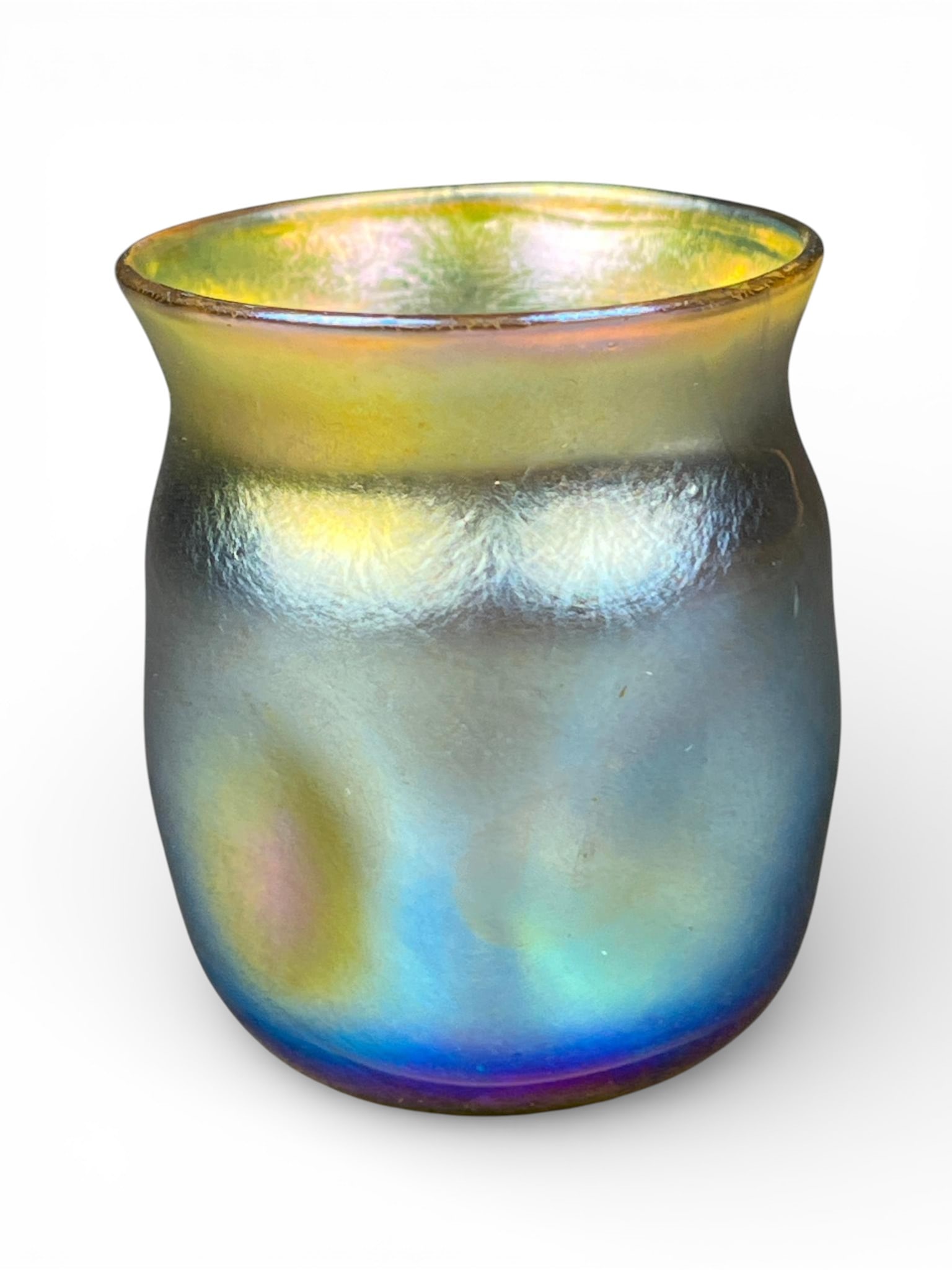 L.C. Tiffany Favrile Iridescent Art Glass Toothpick Holder: A single, small, footless art glass vessel, consistent with forms used for miniature vases, cordials, or tumblers, executed in the Favrile technique. The glass exhibits a vibrant iridescent finish typ