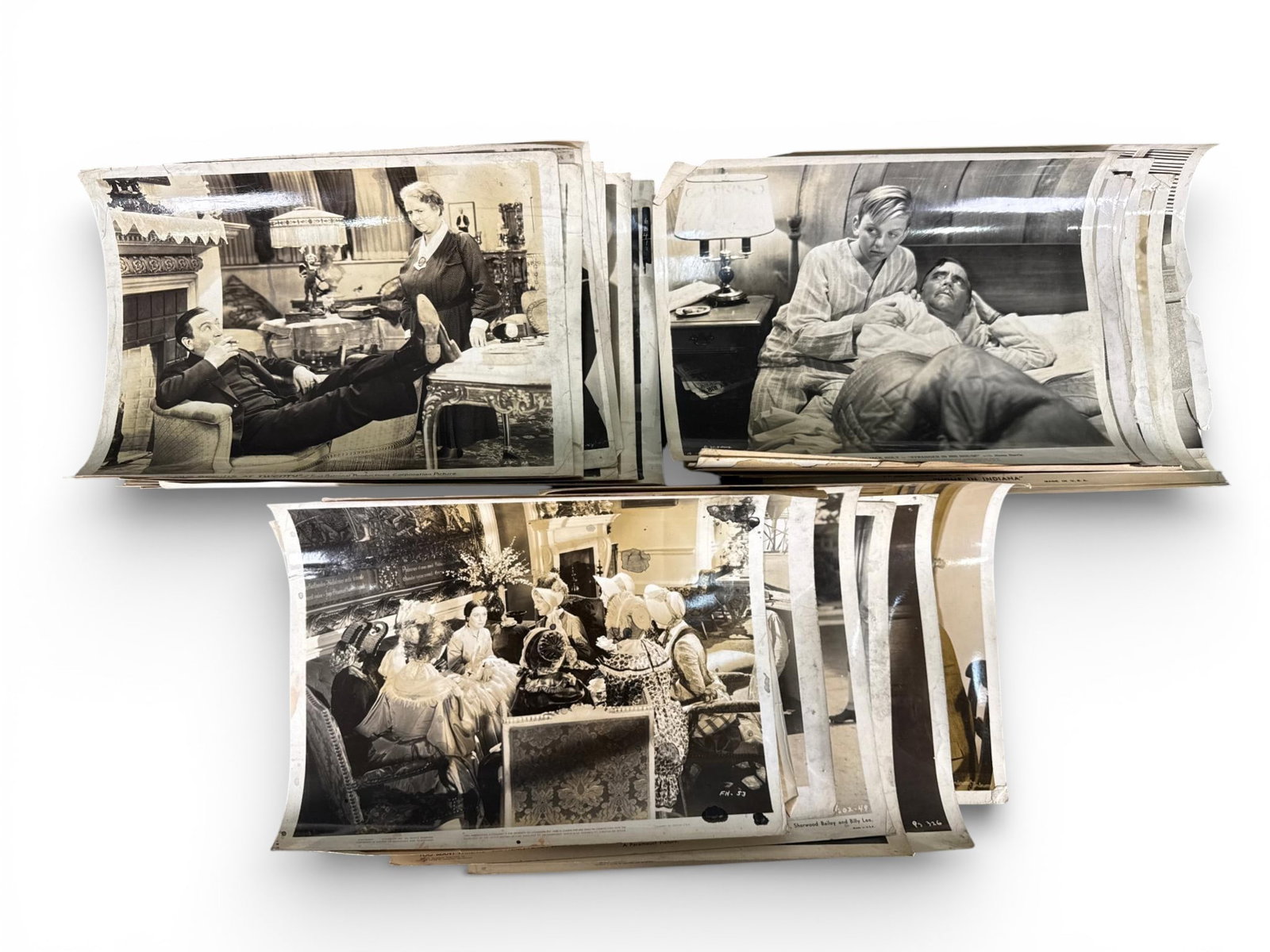 A Group of Vintage Hollywood Promotional Photographs and Movie Stills: A group of black and white photographic prints, predominantly studio movie stills or promotional photographs, dating from the early to mid-20th century, specifically the 1930s to mid-1940s. These