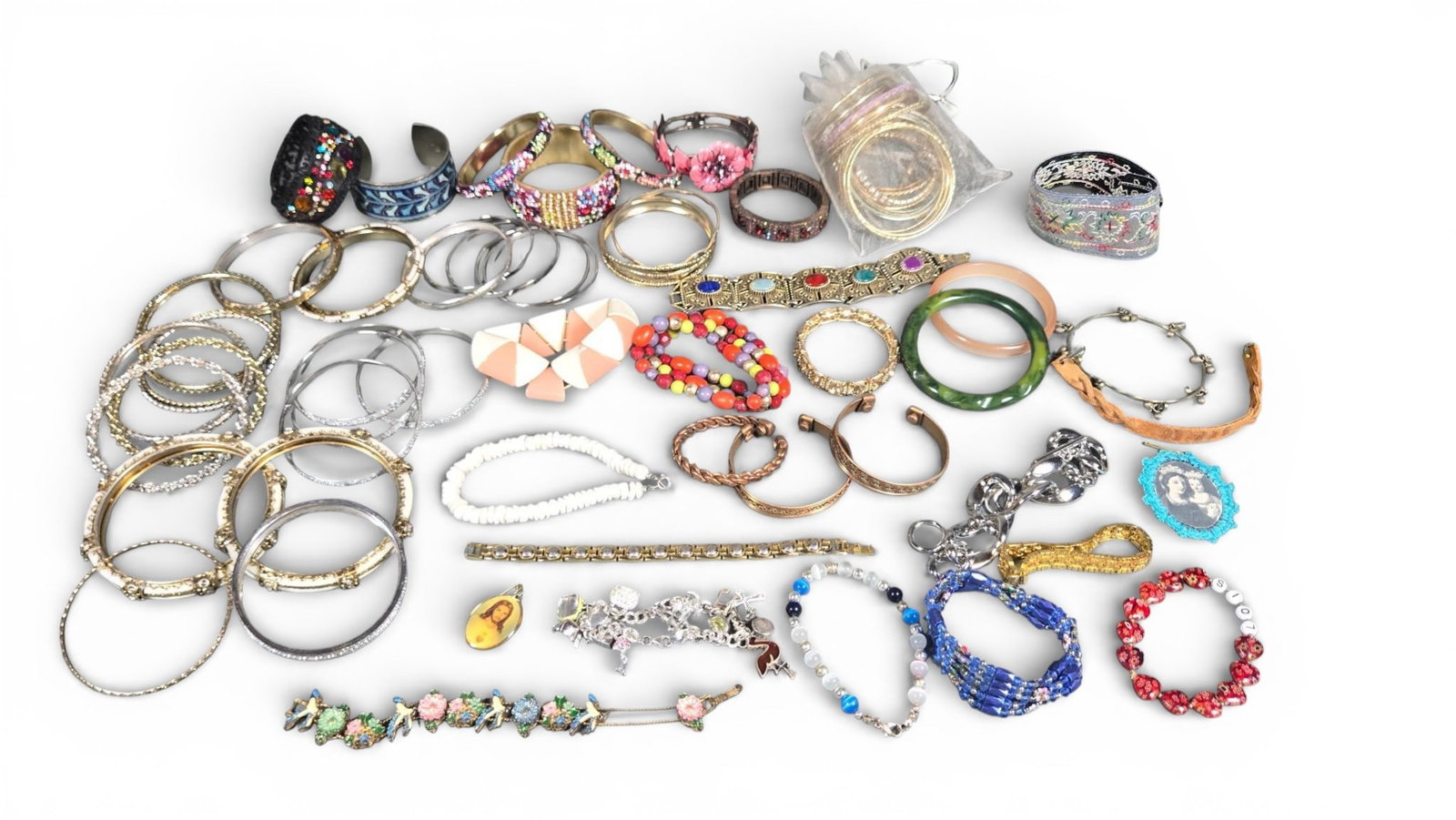 Assorted Bracelets, including Sterling Silver and Costume Jewelry: assorted bracelets, featuring a wide array of styles including bangles, cuffs, chain link, beaded, and stretch designs. Materials observed include gold-toned and silver-toned metals, copper, resin,