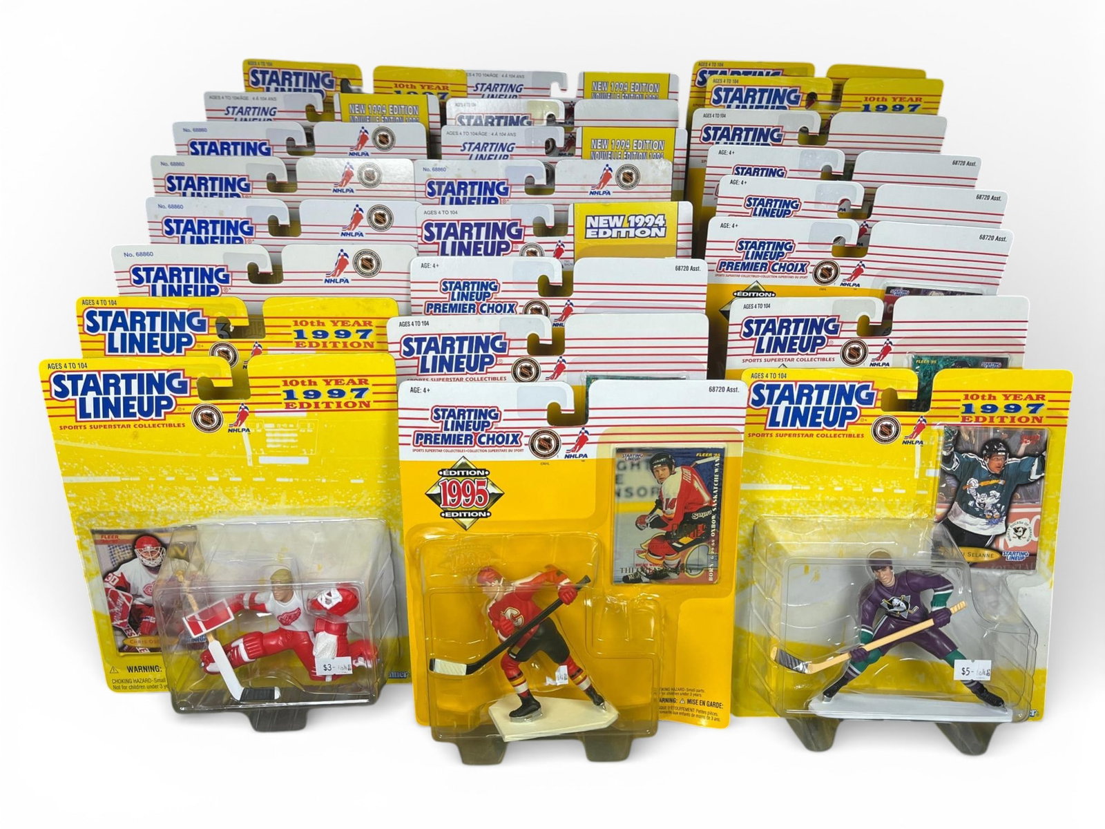 A Collection of Kenner Starting Lineup NHL Hockey Action Figures, 1994-1997 Editions: A collection of Kenner 'Starting Lineup' NHL hockey action figures, primarily from the mid-to-late 1990s, including 'NEW 1994 EDITION,' '1995 EDITION,' '1996 EDITION,' and '1997 EDITION (10th Year)'