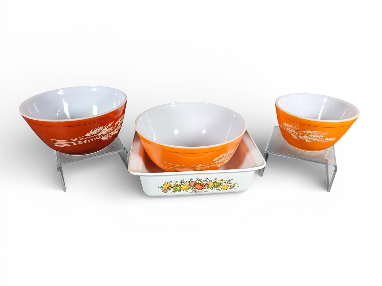 A group of Pyrex Wheat Harvest Mixing Bowls and Corning Ware Spice of Life Casserole Dish: A group of pieces of vintage opal glass kitchenware manufactured by Corning Glass Works, U.S.A. The collection comprises Pyrex mixing bowls in the Wheat Harvest pattern and one Corning Ware casserole