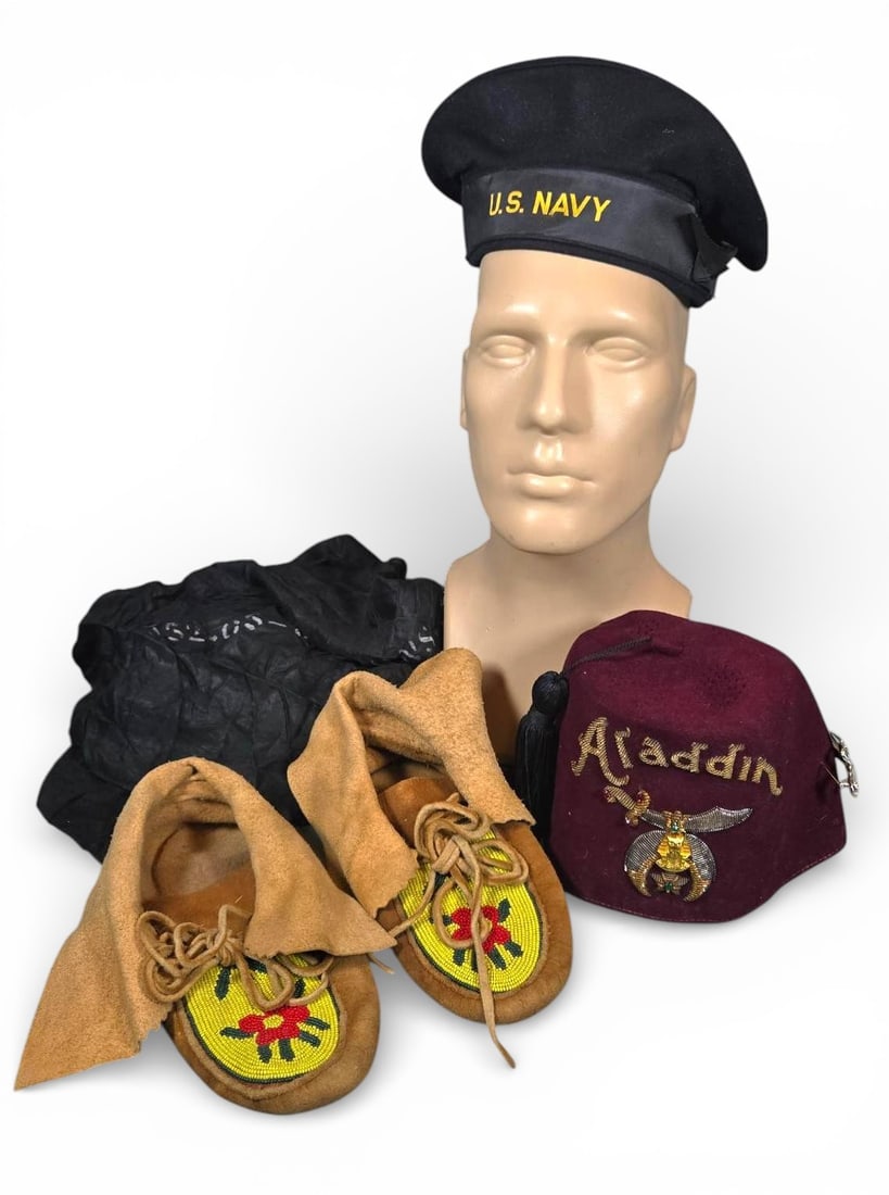 A group of Items Including US Navy Cap, Shriner's Fez, and Beaded Moccasins: A group of diverse textile items, including military, fraternal, and Native American apparel. The lot features tan suede leather moccasins adorned with traditional beadwork. The vamp features a bright
