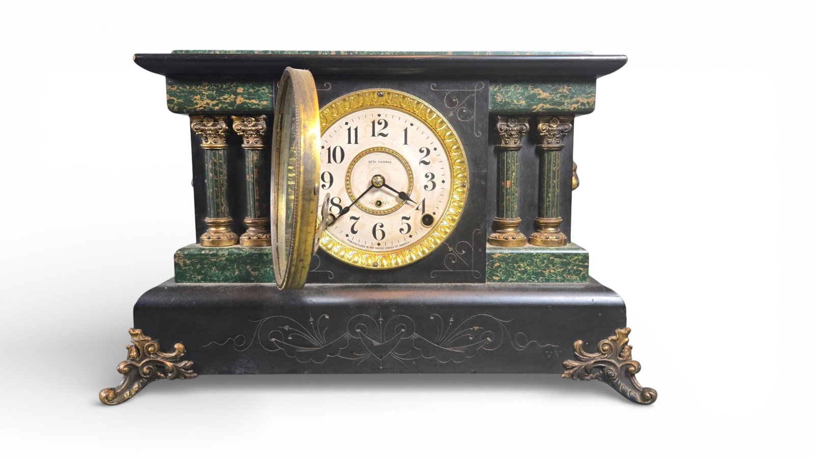 American Neoclassical Revival Faux Marble Mantel Clocks by Seth Thomas and Sessions: late 19th or early 20th century American mantel clocks executed in the Neoclassical Revival style. The wooden cases are finished to simulate black slate and green/gold faux marble, a style often assoc