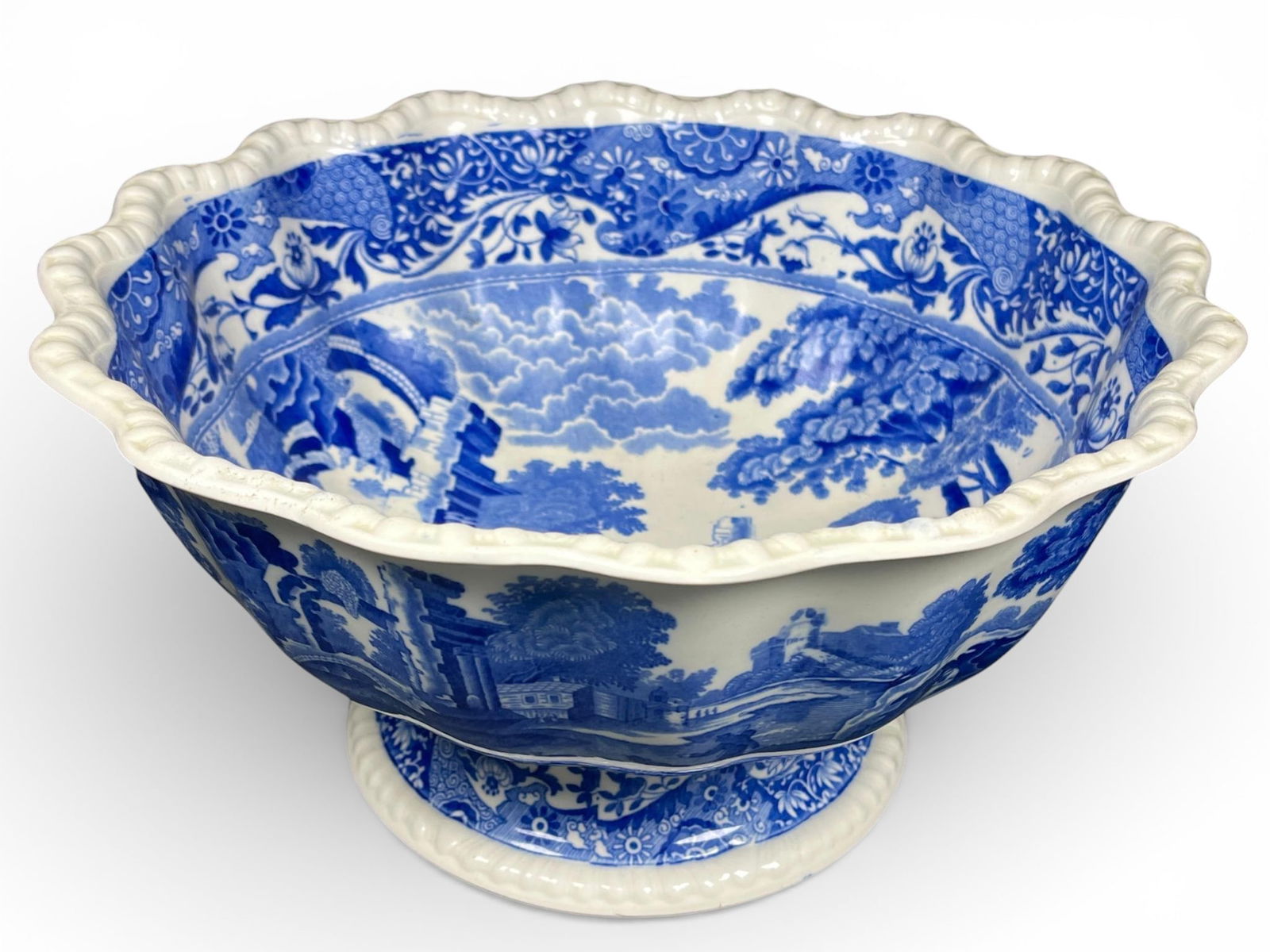 A Copeland Spode Blue Italian Fluted Footed Serving Bowl: A single footed serving bowl manufactured by Copeland Spode in the popular Blue Italian pattern. The piece is constructed of white earthenware and decorated with extensive underglaze blue transferware