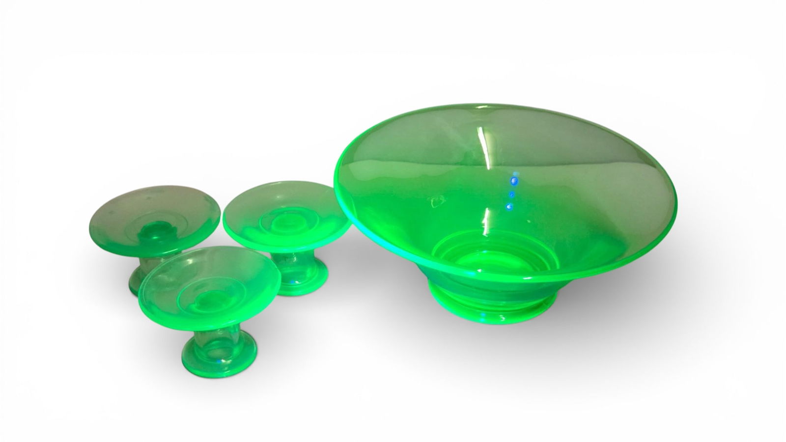 Depression Era Vaseline Uranium Glass Console Set Pieces: A collection of molded glassware, commonly identified as Uranium or Vaseline glass due to its translucent light-green color and strong fluorescence under UV light. This style is consistent with Depres