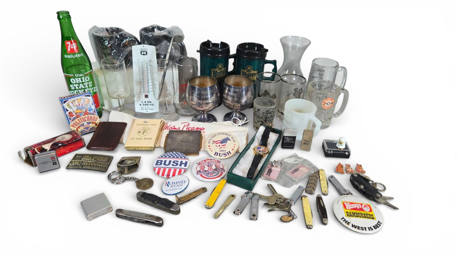 Vintage Advertising and Souvenir Ephemera Junk Drawer Lot: Collection of mid-to-late 20th and early 21st-century promotional and souvenir ephemera, primarily composed of glass, plastic, brass, and composite materials. The lot includes pieces of assorted drink