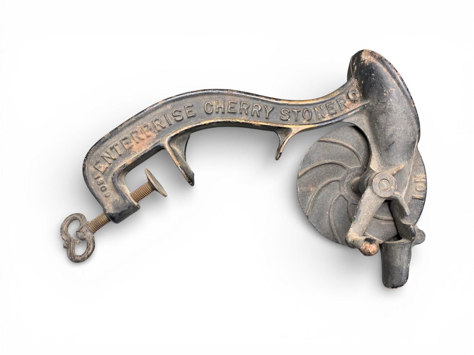 Enterprise No. 1 Cast Iron Mechanical Cherry Stoner: A vintage mechanical cherry stoner manufactured by the Enterprise Manufacturing Co. of Philadelphia, U.S.A. The item is constructed of cast iron and retains a substantial amount of its original black