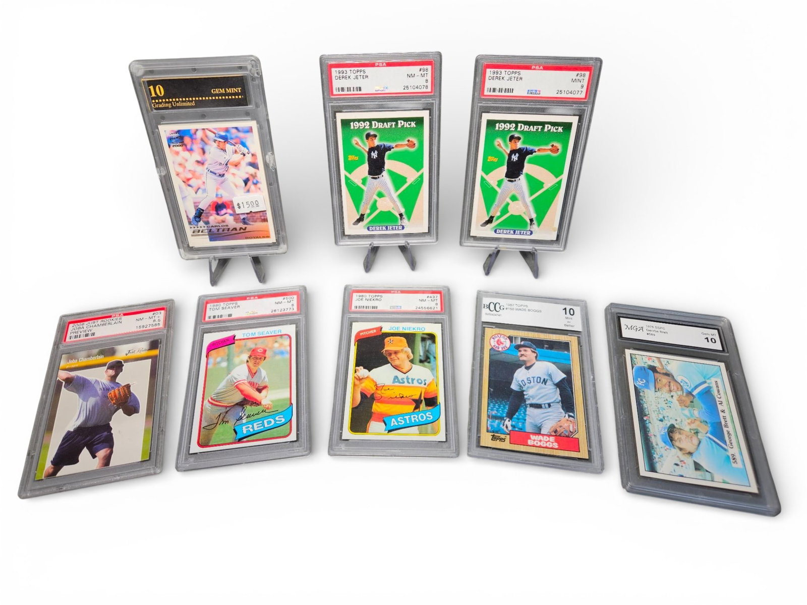 A Collection of Professionally Graded Baseball Trading Cards 1976-2006: A collection of professionally graded baseball trading cards spanning decades, featuring vintage and modern issues. The cards are encapsulated in hard plastic archival slabs from various third-party g