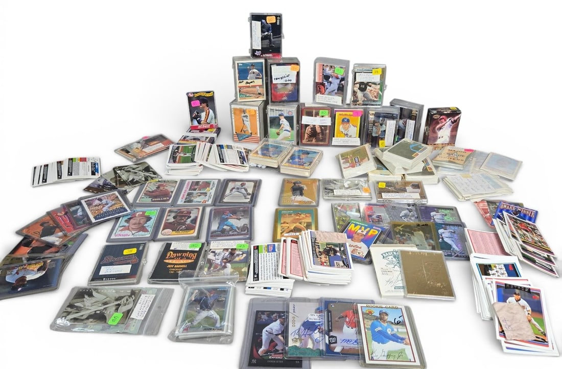 Mixed Baseball Trading Cards Including Autographs and Ken Griffey Jr. 23 Karat Gold Card: The collection features various materials, including standard cardboard stock, modern holographic and chrome issues, and a specific 23 Karat Gold card of Ken Griffey Jr. manufactured by Bleachers. Key