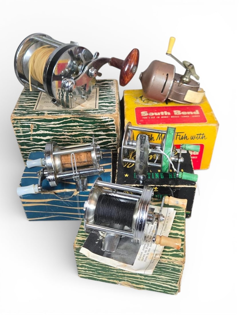 A group of Vintage Fishing Reel and Box Sets including Pflueger, Bronson, and South Bend: A group of vintage fishing reel and box sets. The collection comprises reels, predominantly conventional level-wind baitcasting models, each paired with its original manufacturer cardboard box.