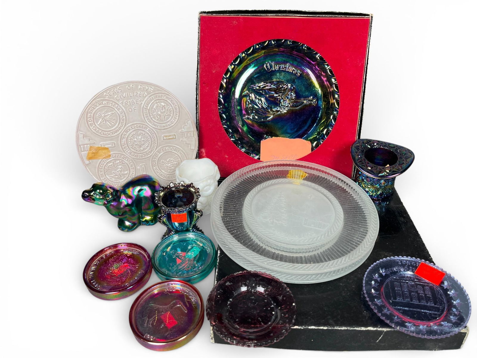 L.E. Smith and Souvenir Pressed Glass and Pottery Items: A group of vintage commemorative and souvenir items, primarily composed of pressed glass and pottery. The collection includes boxed iridescent Carnival glass plates attributed to L.E. Smith, both