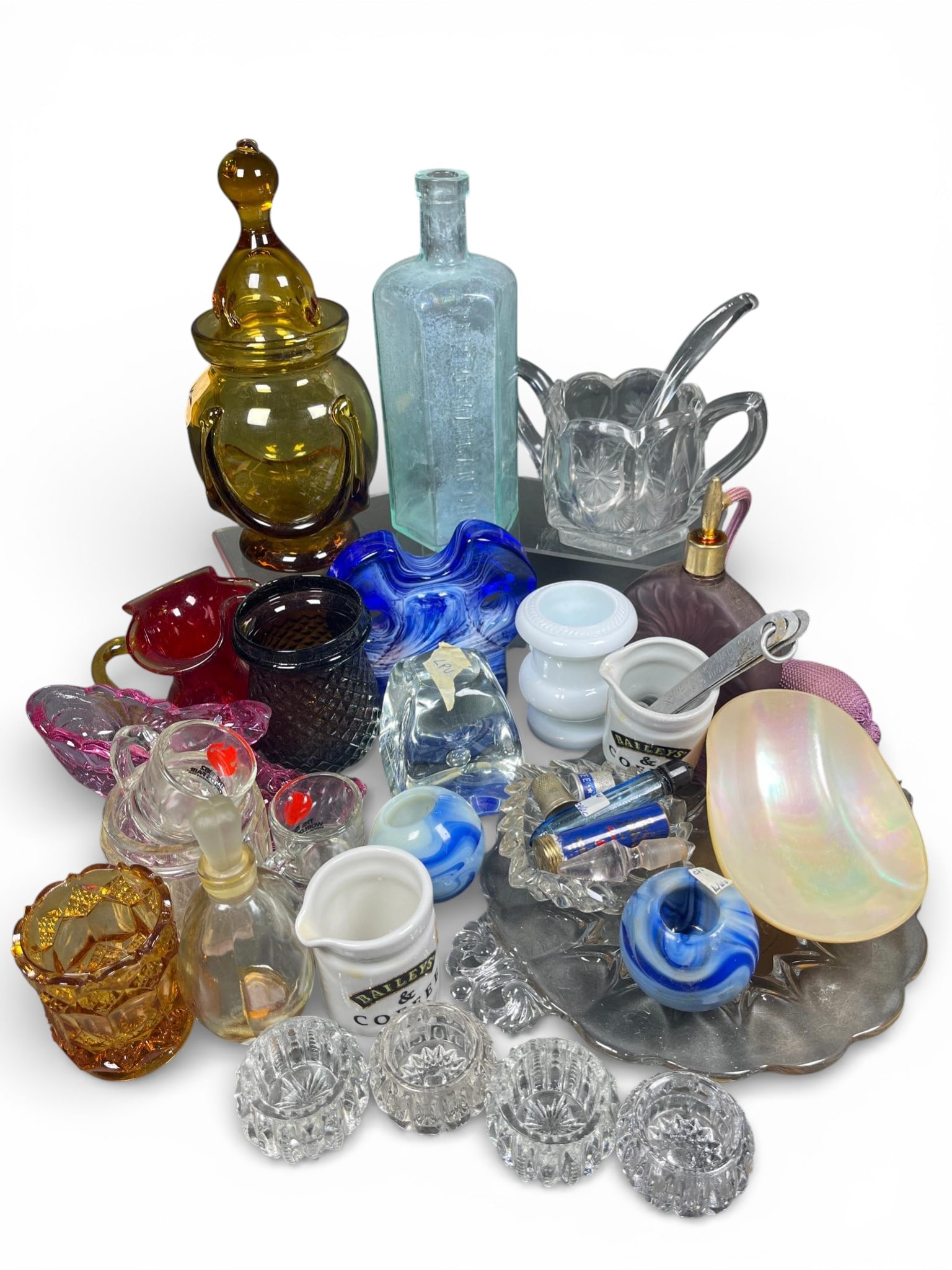 Vintage and Contemporary Glassware and Novelty Wares: A group of assorted vintage and contemporary decorative and utilitarian objects, primarily composed of pressed and blown glass, alongside ceramics, metal, and shell. The glassware is presented in