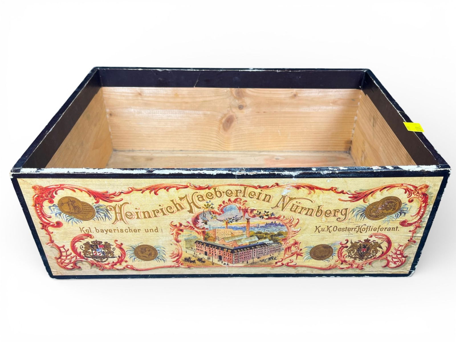 Antique Heinrich Haeberlein Nurnberg Advertising Wood Crate: A vintage wooden advertising crate produced for the German confectionery manufacturer Heinrich Haeberlein of Nurnberg. The crate is constructed of light-colored softwood with dark-painted upper