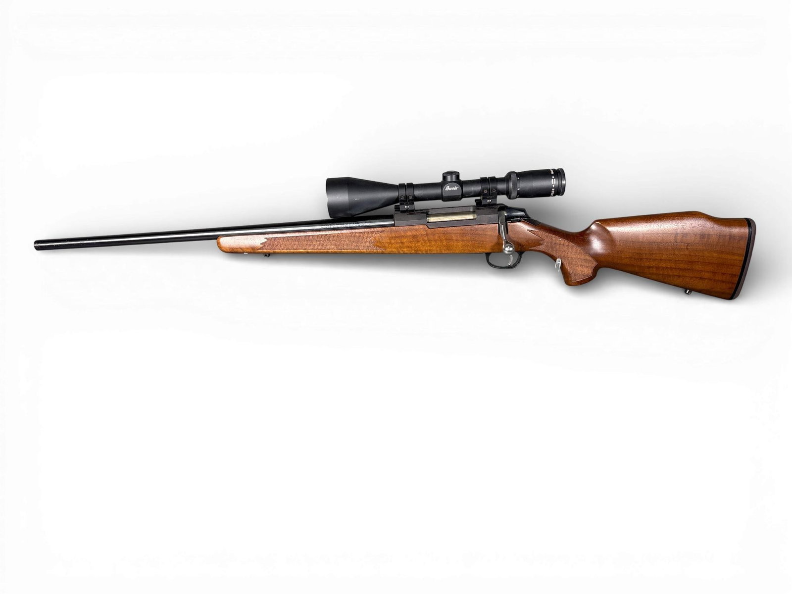 * Tikka M595 Left Handed Bolt Action Rifle: A Tikka M595 left-handed bolt-action rifle chambered in .22-250 Remington. The firearm features a 22.5-inch blued steel barrel and a checkered walnut stock with a pistol grip and black rubber recoil p