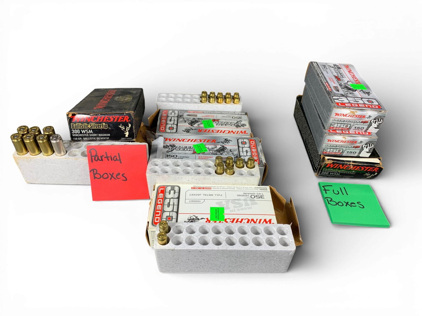 A Collection of Winchester .350 Legend and .300 WSM Rifle Ammunition: A collection of Winchester rifle ammunition featuring .350 Legend and .300 Winchester Short Magnum (WSM) cartridges. The group includes .350 Legend Deer Season XP with 150-grain Extreme Point bullets,