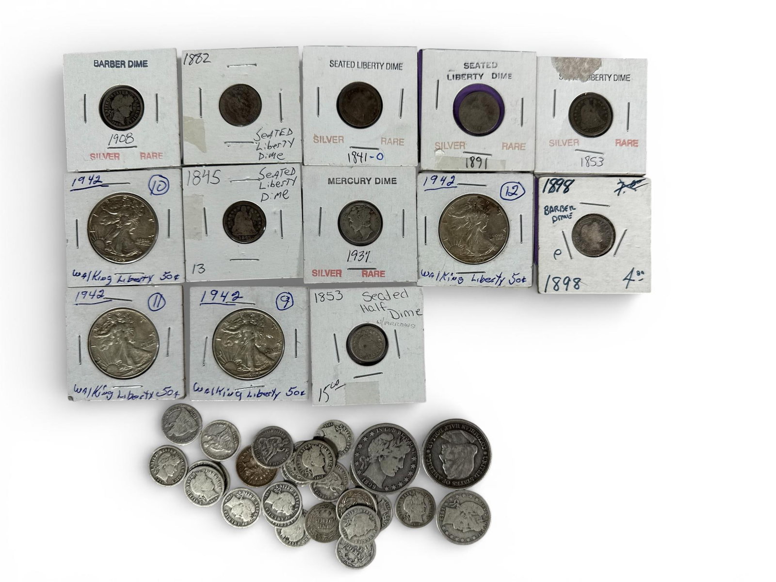 A Collection of United States Silver Coins and more: A collection of United States silver and copper-alloy coinage spanning the mid-19th to mid-20th centuries. The group includes several Walking Liberty half dollars dated 1942, an 1893 Columbian Exposit