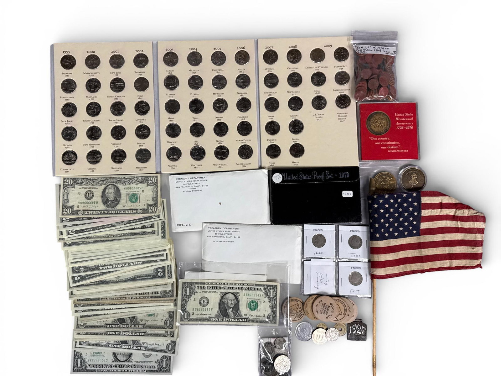 A Collection of United States State Quarters, Currency, and Commemorative Numismatics: This collection includes a set of United States State and territory quarters issued between 1999 and 2009, presented in a trio of cardboard display folders. The lot contains a group of United States p