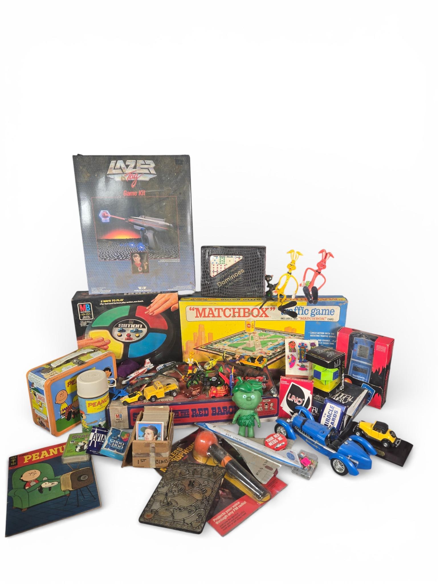 A Group of Assorted Vintage Toys and Games: This collection of vintage toys and games features a variety of items from the late 20th century. The lot includes a boxed Worlds of Wonder Lazer Tag Game Kit with blaster and sensor, a boxed Milton B